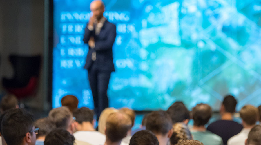 Image of a man giving a presentation to an audience